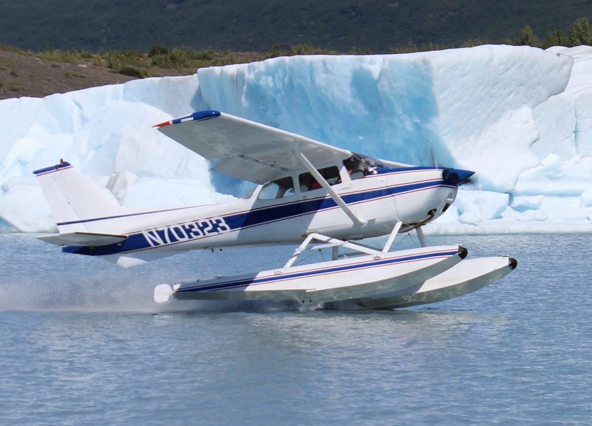 Cessna 172 taking off in front of glacier